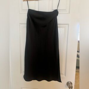 In a new condition, worn once, the elegant skirt has two cuts on both sides.